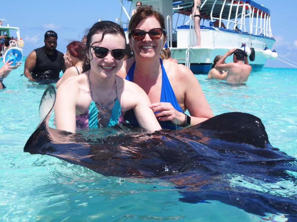 Beautful ladies with stingray fish at cayman islands