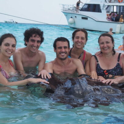 Family playing with Stingray fish at Cayman islands